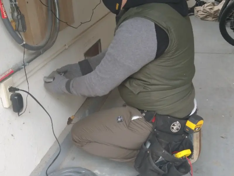 Electrician performing outlet wiring in a Wildwood garage